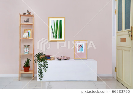Pink wall, table, picture frame 66383790