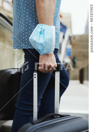 man wearing a surgical mask in his arm man wearing a surgical mask in his arm 66383903