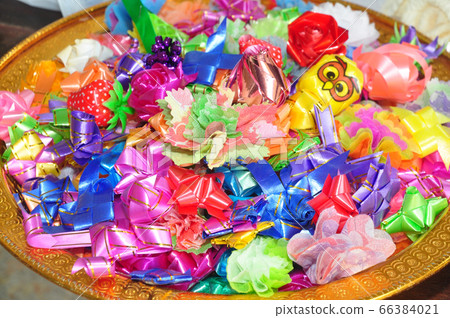 almsgiving with ribbon-flowers 66384021