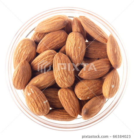 Almonds in glass bowl isolated on white background 66384023