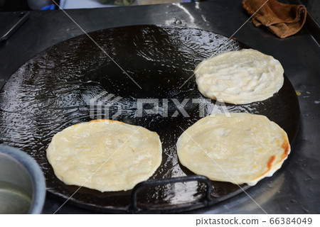 Soft focus of Fried Roti on a hot frying pan Soft focus of Fried Roti on a hot frying pan 66384049