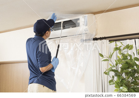 House cleaning worker cleaning the air conditioner 66384569
