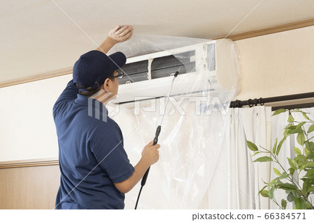 House cleaning worker cleaning the air conditioner 66384571