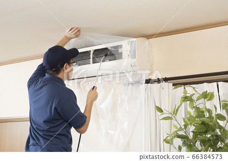 House cleaning worker cleaning the air conditioner House cleaning worker cleaning the air conditioner 66384573