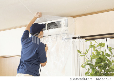 House cleaning worker cleaning the air conditioner 66384692
