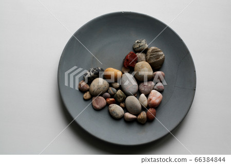 Sea stones arranged in heart shaped form isolated on grey concrete plate from a high angle view Sea stones arranged in heart shaped form isolated on grey concrete plate from a high angle view 66384844