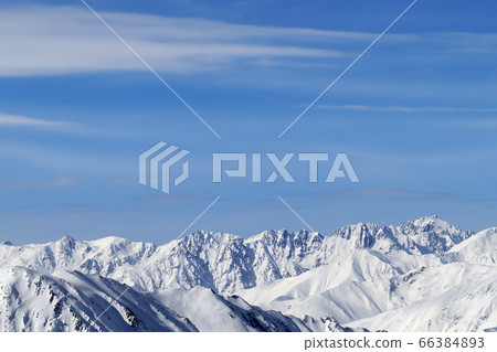 High snowy mountains and blue sky with clouds High snowy mountains and blue sky with clouds 66384893