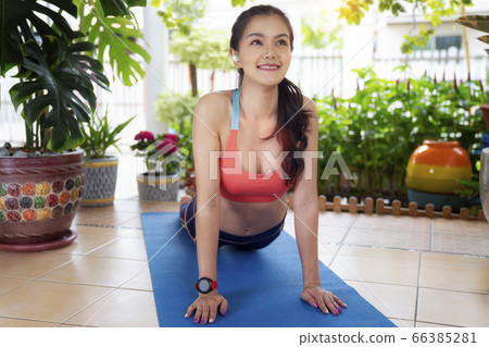 Asian girl exercise at home with garden background 66385281