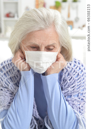 Ill beautiful senior woman with facial mask 66388153