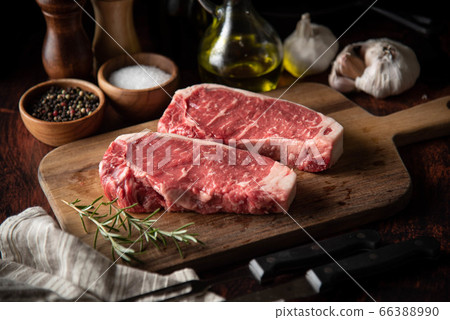 raw strip beef steak meat on wooden cutting board raw strip beef steak meat on wooden cutting board 66388990