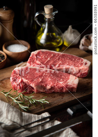 raw strip beef steak meat on wooden cutting board raw strip beef steak meat on wooden cutting board 66388991