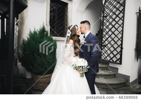 Romantic wedding moment, couple of newlyweds smiling portrait, bride and groom hugging Romantic wedding moment, couple of newlyweds smiling portrait, bride and groom hugging 66389008