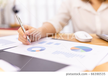 Young woman sale person analzing sale report on desk working at home 66390535