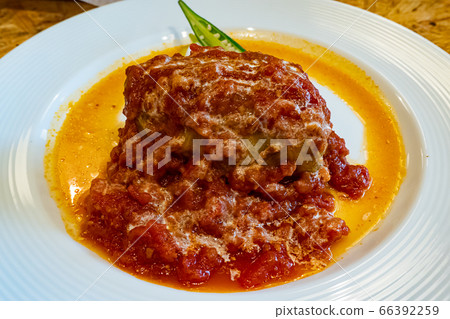 Rolled cabbage white plate with tomato sauce next to Shiba Koen Bistro Roven lunch Rolled cabbage white plate with tomato sauce next to Shiba Koen Bistro Roven lunch 66392259