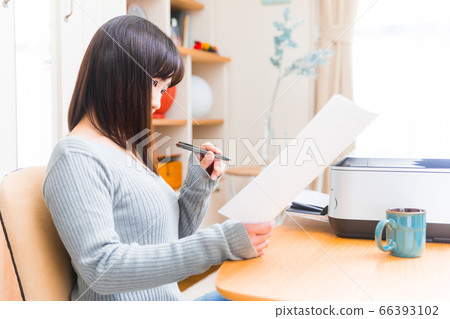 Woman checking documents Various documents Telework application Certification application Request application Resume, etc. 66393102