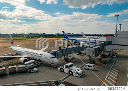 Fukuoka Airport Daytime Sunny weather View from boarding gate Passenger planes and boarding bridge Runway in the background 66393224