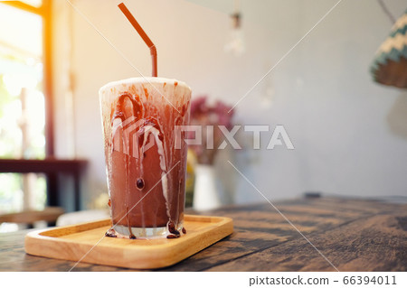 Iced chocolate shake on wood and sunlight Iced chocolate shake on wood and sunlight 66394011