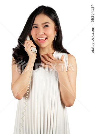 young woman looking happy while talking on the 66394134
