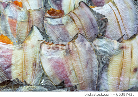 Lot of salted dried fish ocean plaice. Background of group flatfish with caviar. Close-up flat lay view of prepared and ready-to-eat Pacific seafood 66397433
