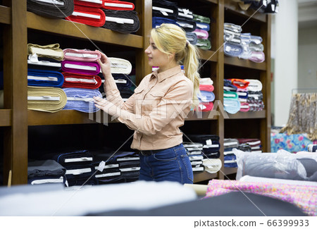 Woman looking for cloth in shop 66399933
