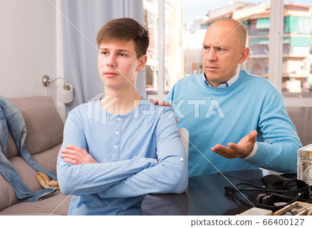 Man scolding son at home Man scolding son at home 66400127