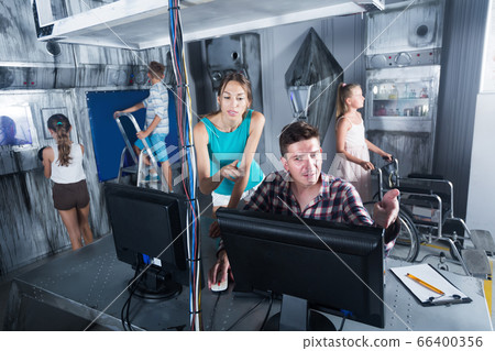 Family using PC in escape room under laboratory Family using PC in escape room under laboratory 66400356