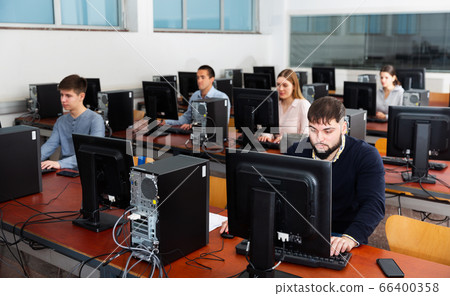 Group of people learning to use computers in classroom Group of people learning to use computers in classroom 66400358