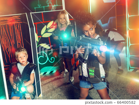 African girl playing lasertag with friends 66400582