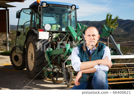 Man near tractor in vineyard Man near tractor in vineyard 66400621