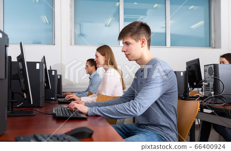 Side view of focused female and male working Side view of focused female and male working 66400924