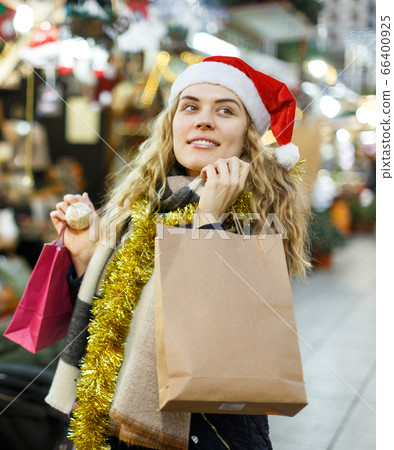 Woman holding bags with Christmas toys Woman holding bags with Christmas toys 66400925
