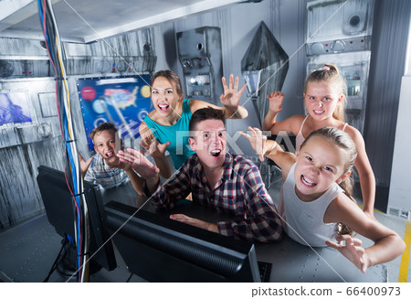 Cheerful family is passing of quest room 66400973