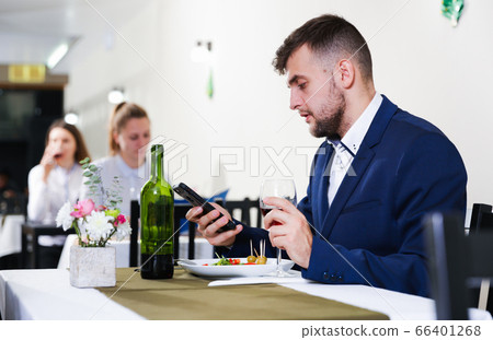 Man is dinnering in luxury restaurante alone Man is dinnering in luxury restaurante alone 66401268