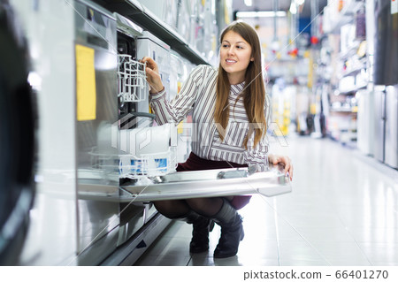 Girl buying dishwasher in store Girl buying dishwasher in store 66401270