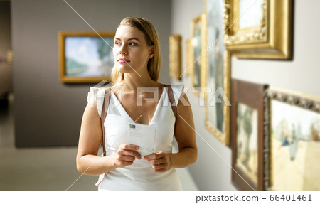 Woman visiting painting exhibition Woman visiting painting exhibition 66401461