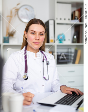 Doctor working effectively in her office Doctor working effectively in her office 66401496