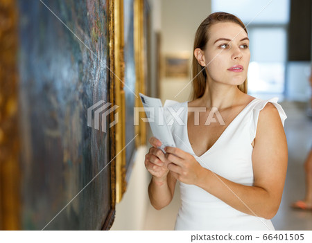 Woman visiting painting exhibition Woman visiting painting exhibition 66401505