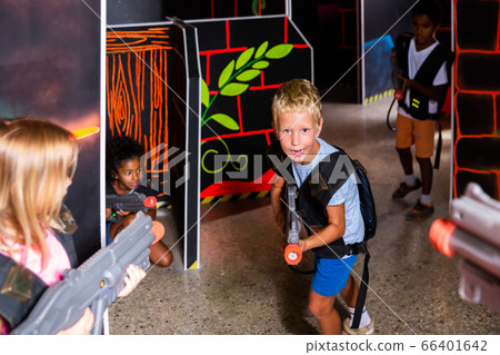Portrait of laughing tweenager boy with laser gun Portrait of laughing tweenager boy with laser gun 66401642