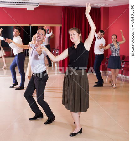 Young smiling people dancing samba in pairs Young smiling people dancing samba in pairs 66401860