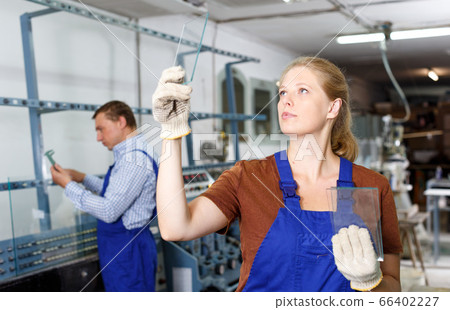 Female glazier working in glass factory Female glazier working in glass factory 66402227