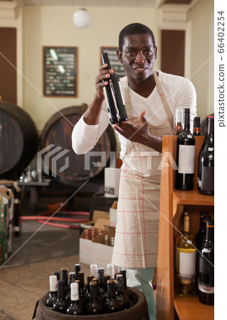 salesman recommending bottle of wine salesman recommending bottle of wine 66402254