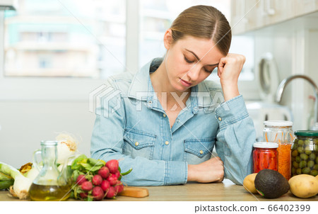 Woman suffering from headache at kitchen Woman suffering from headache at kitchen 66402399