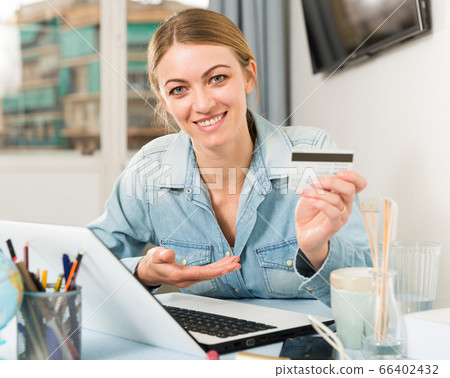 Smiling woman shopping online Smiling woman shopping online 66402432