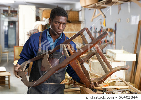 Professional restorer renewing vintage armchair 66402844