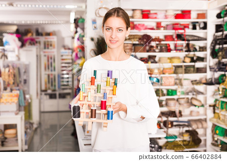 Female seller showing threads 66402884
