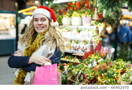 Girl holding paper bags at Christmas fair Girl holding paper bags at Christmas fair 66402970