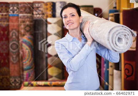 Female keep in hand colored carpet in interior shop Female keep in hand colored carpet in interior shop 66402971