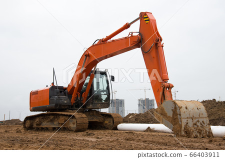 Excavator during earthworks at construction site 66403911