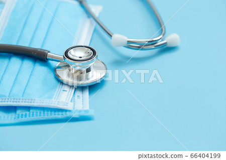 Medical stethoscope and hygiene prevention face mask protection protective virus on blue background. 66404199