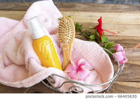 hair care serum for damaged hairs with comb health care beauty head and hairs with terry cloth in basket  66405630